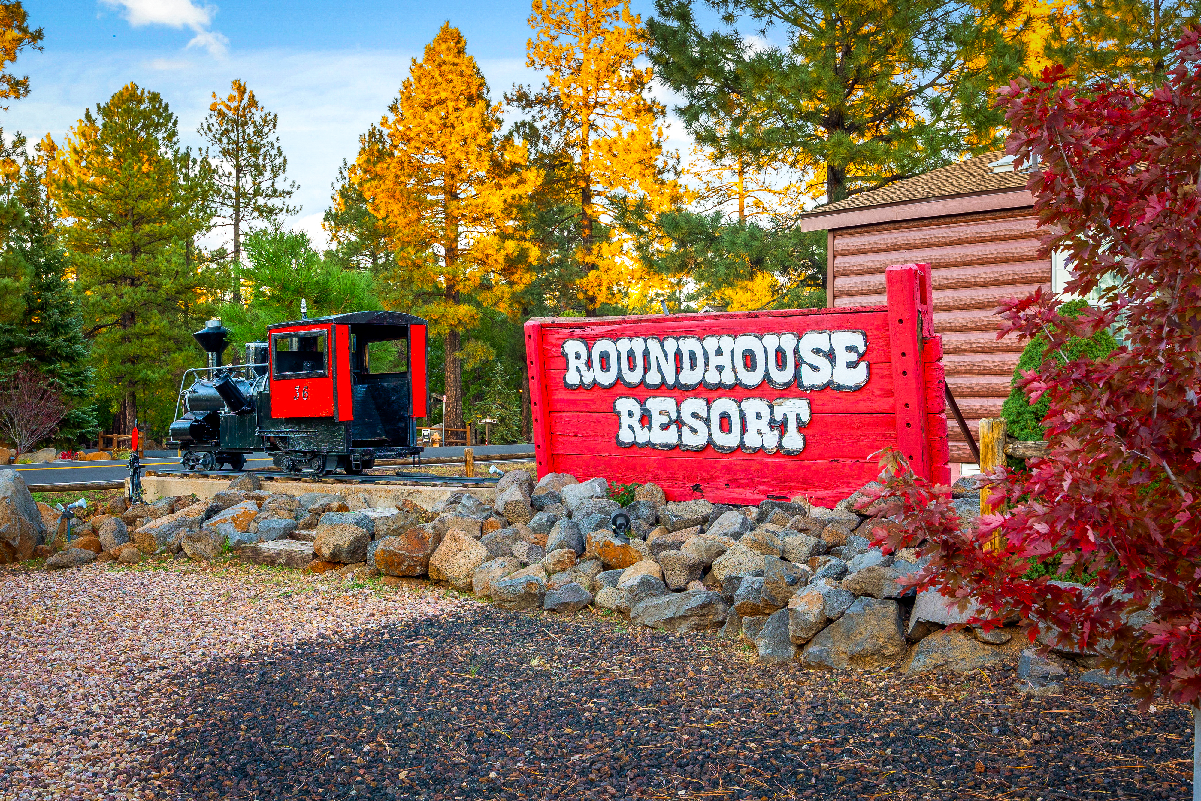 Round House Resort sign with miniature train and fall foliage